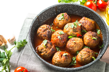 Meatballs in tomato sauce in a frying pan. 