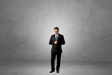 Alone businessman standing in a dark room