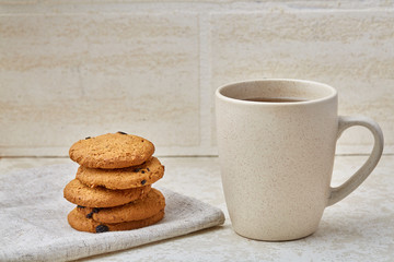 Cup of coffee and biscuit isolated on the white background, close-up, shallow depth of field.