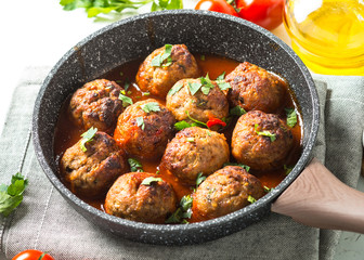Meatballs in tomato sauce in a frying pan. 