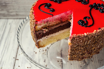 sponge cake with fruit jelly on wooden background
