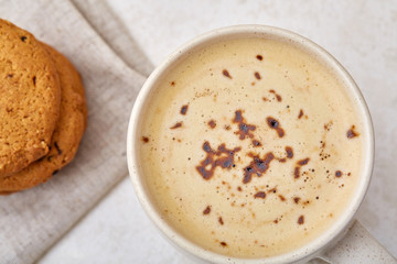 Cup of coffee and biscuit isolated on the white background, close-up, shallow depth of field.