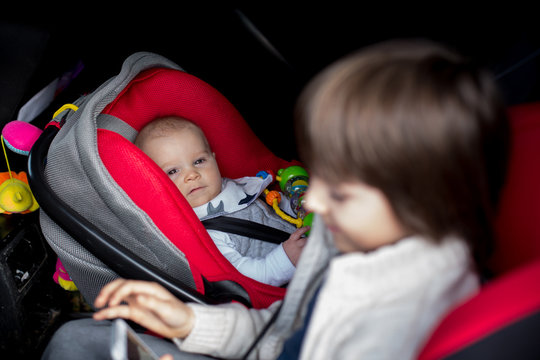 Little Baby Boy And His Older Brother, Traveling In Car Seats, Going On A Holiday