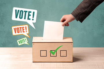 placing a voting slip into a ballot box