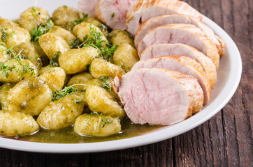 Pork tenderloin with herbs and spices, pesto gnocchi