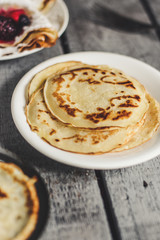Pancakes (crepes) on a wooden surface
