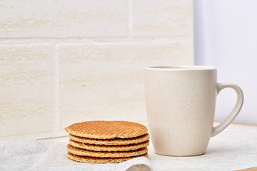 Cup of coffee and biscuit isolated on the white background, close-up, shallow depth of field