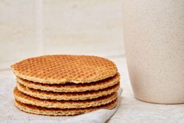 Cup of coffee and biscuit isolated on the white background, close-up, shallow depth of field