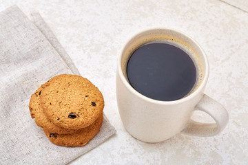 Cup of coffee and biscuit isolated on the white background, close-up, shallow depth of field.