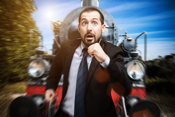 Businessman escaping from an antique train