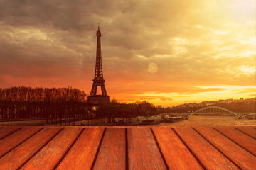 Empty wooden floor and Eiffel tower landscape view on sunset.