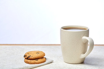 Cup of coffee and biscuit isolated on the white background, close-up, shallow depth of field.