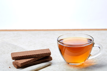 Top view close up picture of glass teacup with waffles isolated on white background, shallow depth...