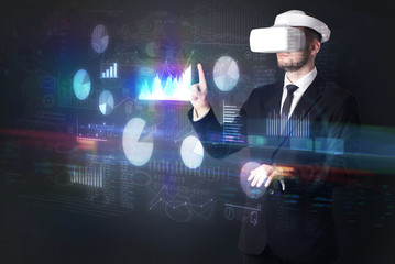 Man wearing VR goggles with charts and reports