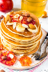 Breakfast oatmeal pancakes with banana, walnuts and honey