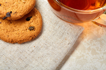 Top view close up picture of glass teacup with biscuits isolated on white background, frontfocus, shallow depth of field