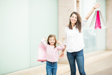 Fototapeta na wymiar Latin mother and daughter on shopping spree in a mall