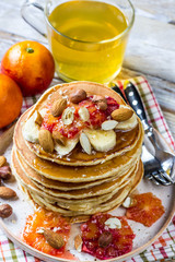 Breakfast oatmeal pancakes with banana, walnuts and honey