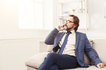 Serious businessman having phone talk