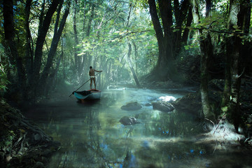 un homme navigue sur une barque dans la forêt tropicale