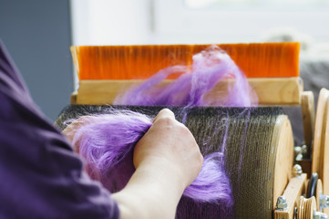 Fototapeta premium Felting wool. The step of combing the material in a special carding machine.