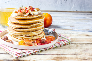 Breakfast oatmeal pancakes with banana, walnuts and honey