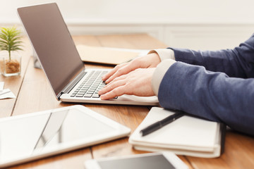 Fototapeta na wymiar Unrecognizable businessman typing on laptop