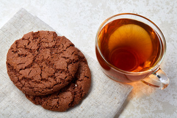 Top view close up picture of glass teacup with biscuits isolated on white background, frontfocus, shallow depth of field