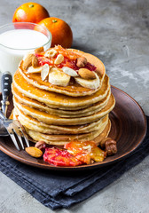 Breakfast oatmeal pancakes with banana, walnuts and honey