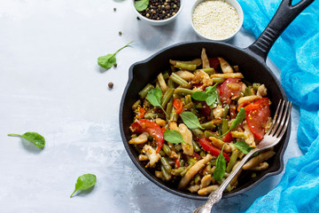 Vitamin lunch with chicken, green beans, arugula, tomatoes and vinaigrette sauce, stone or slate background. Proper nutrition. Healthy lifestyle.
