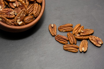 Pecan nuts on stone background. Healthy food