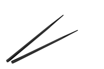 Pair of black chopsticks on white