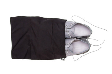 Gray shoes in a bag. Shoes put away for storage in a textile bag.