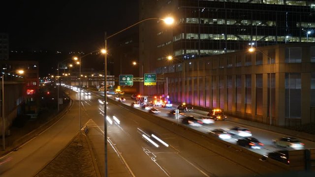 Time lapse of Traffic trying to get around an accident on a highway near urban city at night