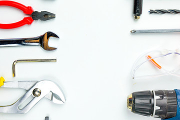 Set of construction tools on white background as wrench, hammer, pliers, socket wrench, spanner, tape measure, electric drill,safety glasses, screwdriver