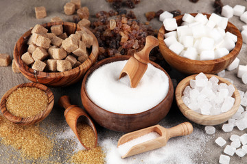 Various types of sugar, brown sugar and white on table