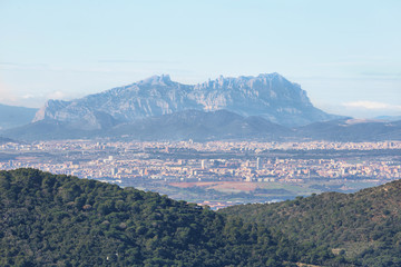 Fototapeta na wymiar Montserrat multi-peaked mountain at background and towns in the surrounding area