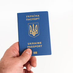 Man's Hand holding Ukrainian biometric passport isolated on white background