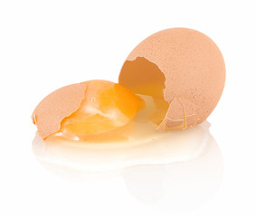 Broken home growth brown chicken egg isolated on white background with shadow reflection. Fallen...