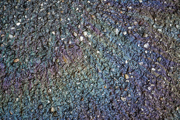 Oil spill on asphalt road, abstract background or texture foe web site or mobile devices