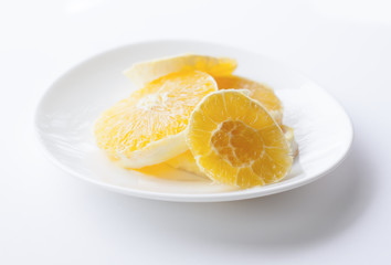Sliced orange on a whiite plate