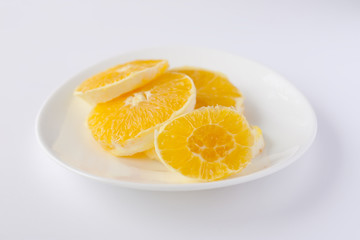Fototapeta na wymiar Sliced orange on a whiite plate