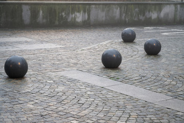Cobblestone street pavement on a square with round decorative stone in the evening