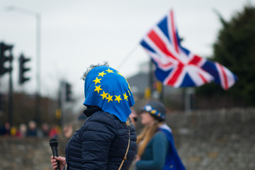 Woman Brexit protestor using microphone with EU headscarf and UK flag