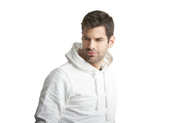 Portrait of young man in casual clothes standing against at isolated white background with copy space. 