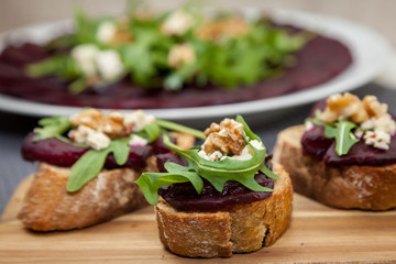 Homemade sandwich with beetroot, feta cheese, rocket salad and walnuts - healthy food
