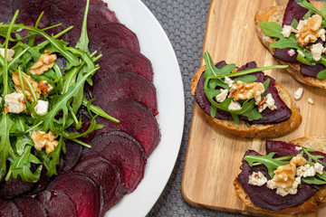 Homemade toast with beetroot, feta cheese, rocket salad and walnuts - healthy food