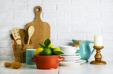 Limes and lemons in a bowl on the table in the kitchen