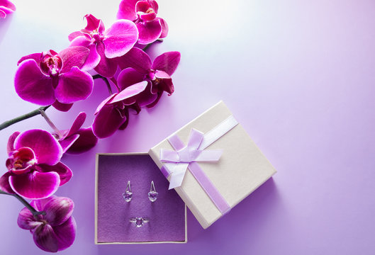 Silver earrings with amethyst in the gift box with orchid