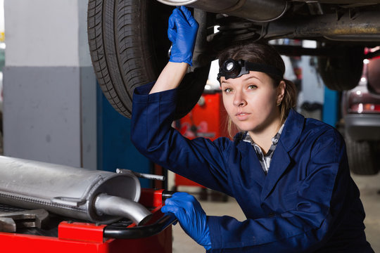 Portrait of girl professional master repairing car